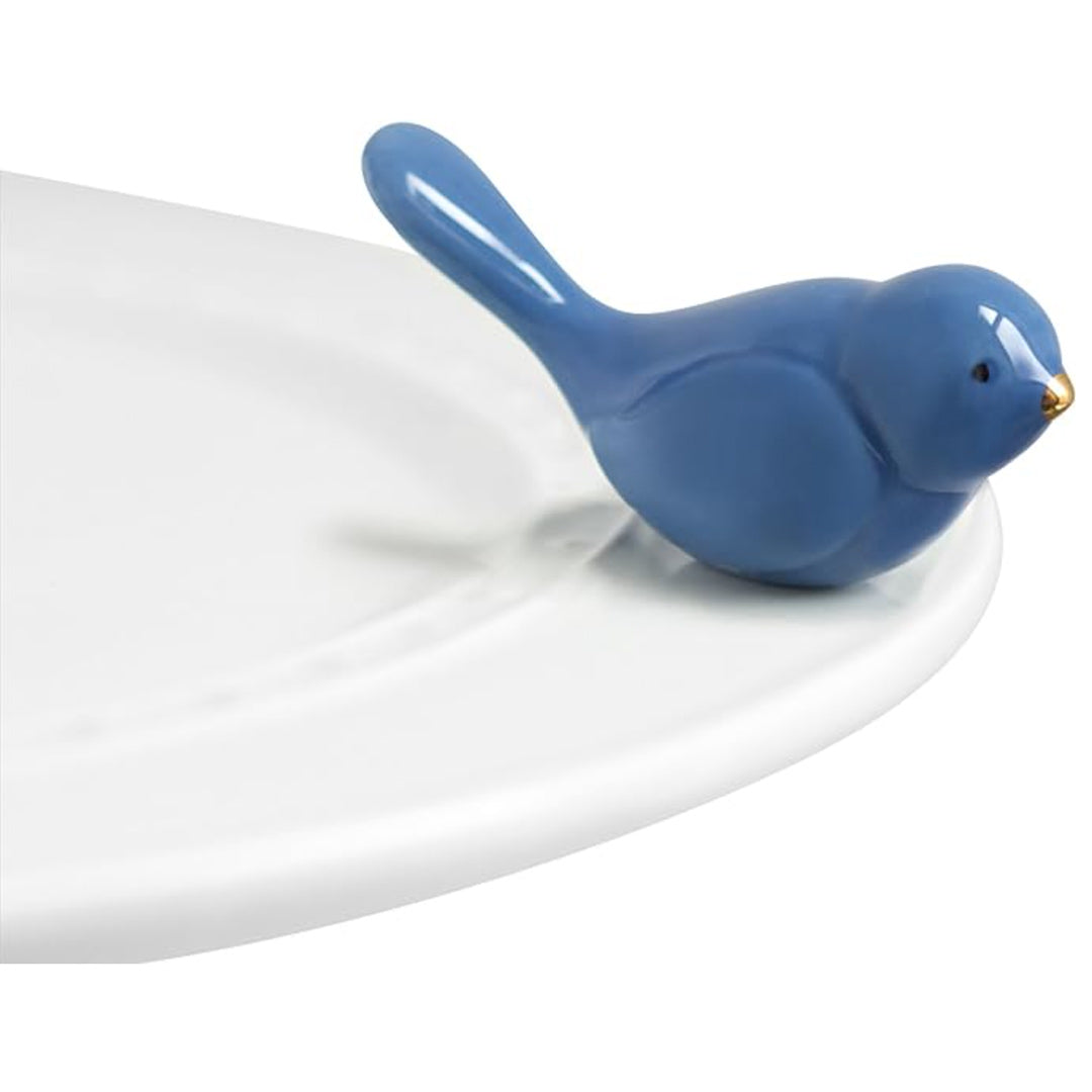 Nora Fleming Bluebird Mini on the plate